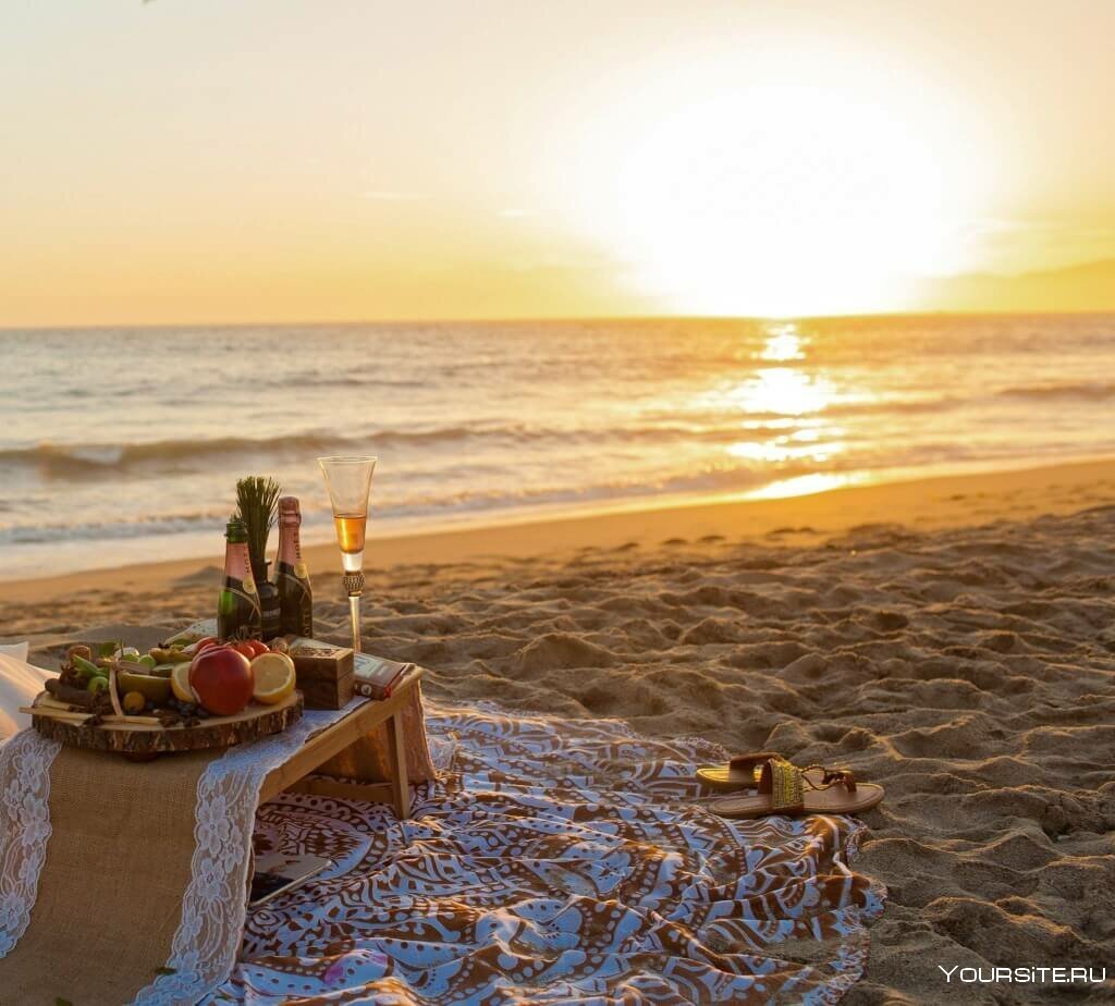 Фрукты шампанское на берегу моря