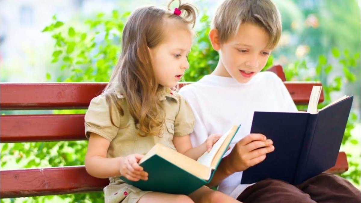 Мальчик и девочка читают книгу