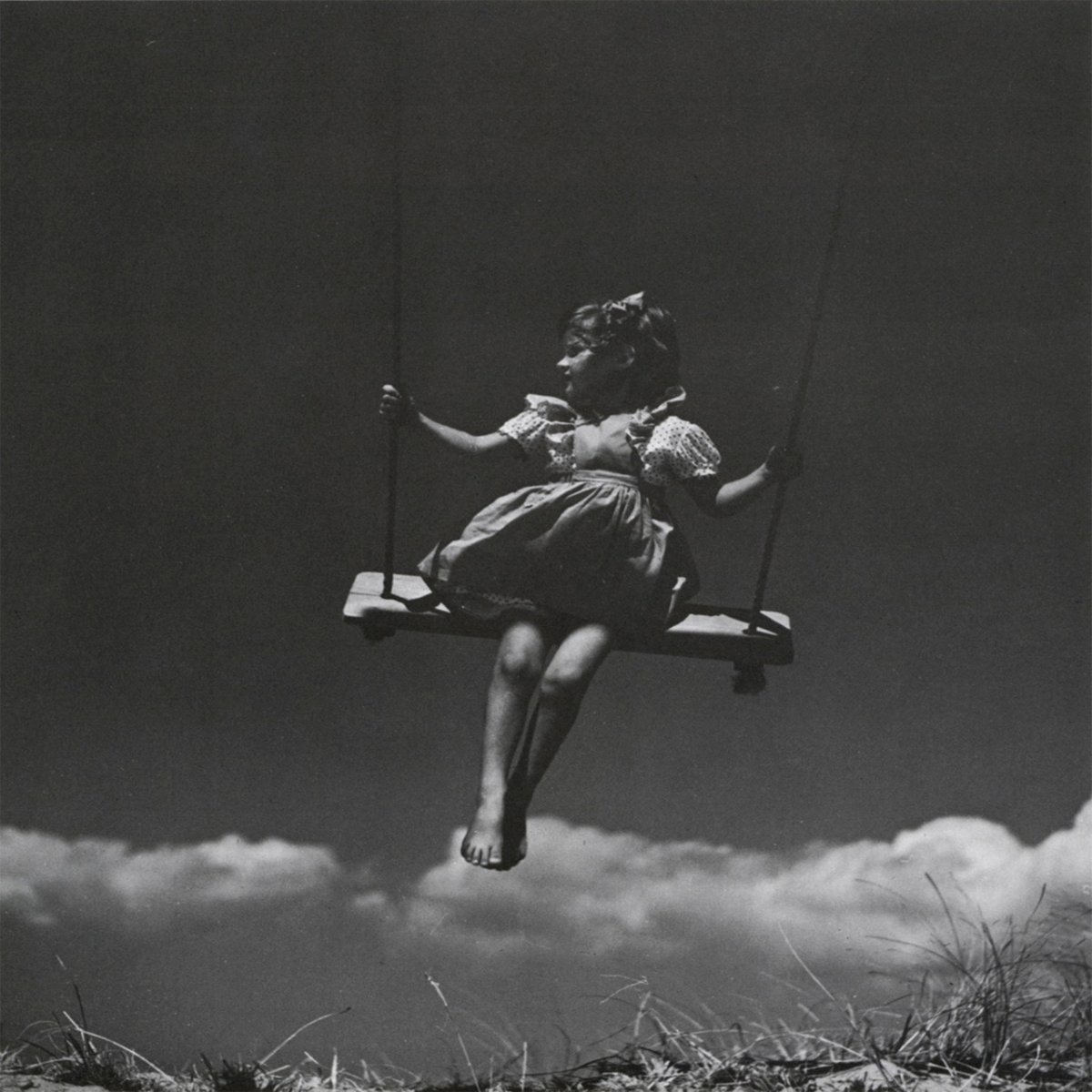 Девочка на качелях на закате