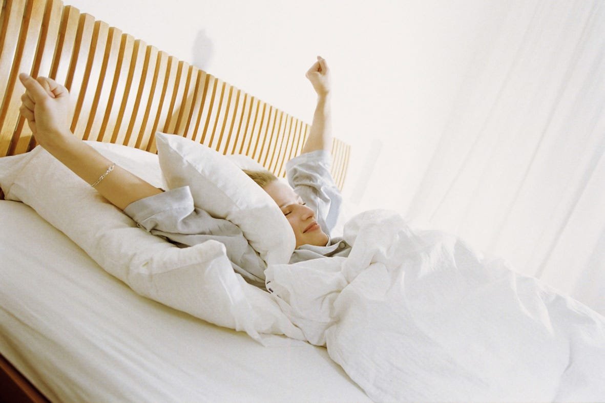 Девушка потягивается в кровати