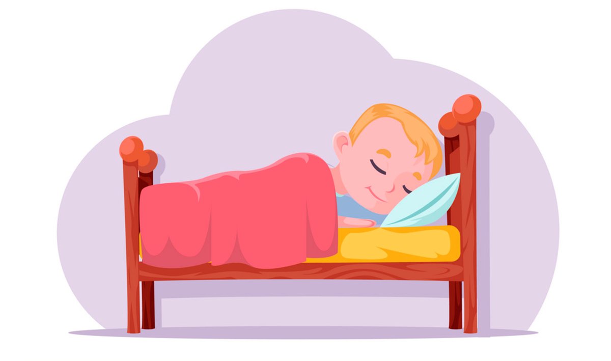 Мальчик спит в кроватке